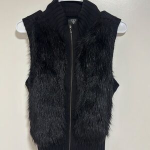 Guess black faux fur vest with a ribbed knit back and a front zipper closure